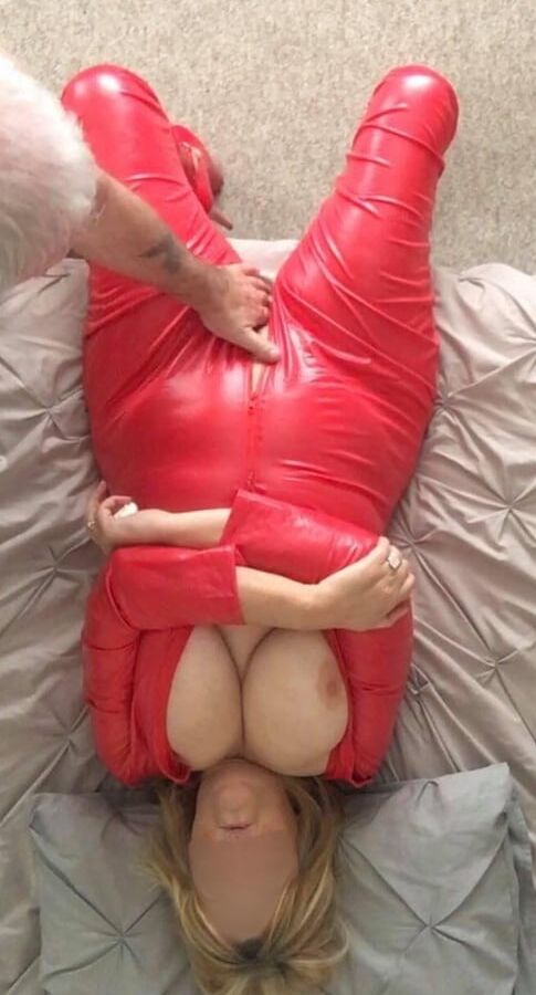 LINDA in a red jumpsuit inch heals