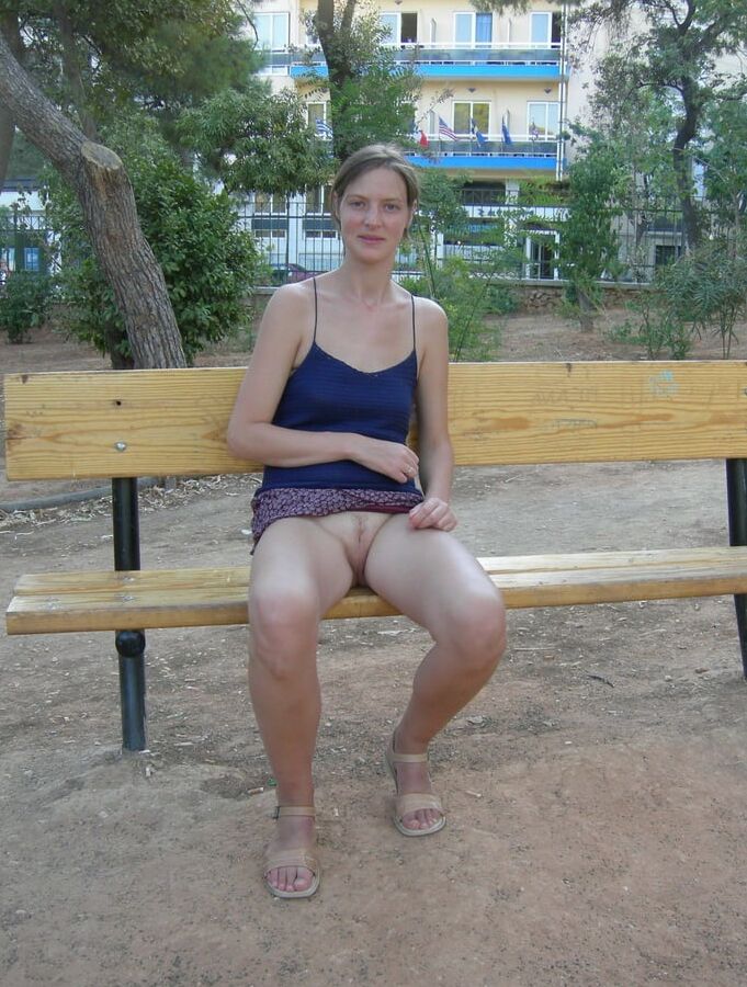 Skinny MILf slut flashes her cunt upskirt in public