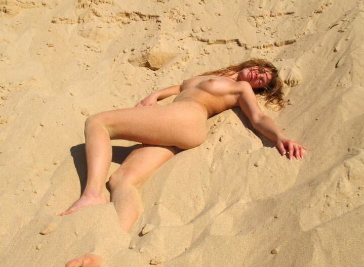 Lovely blonde with sexy body posing on beach