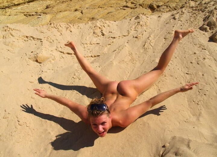 Lovely blonde with sexy body posing on beach