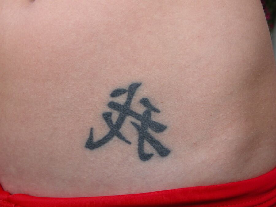 With a tattoo