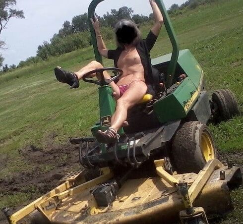 Neighbor lady mowing her lawn today