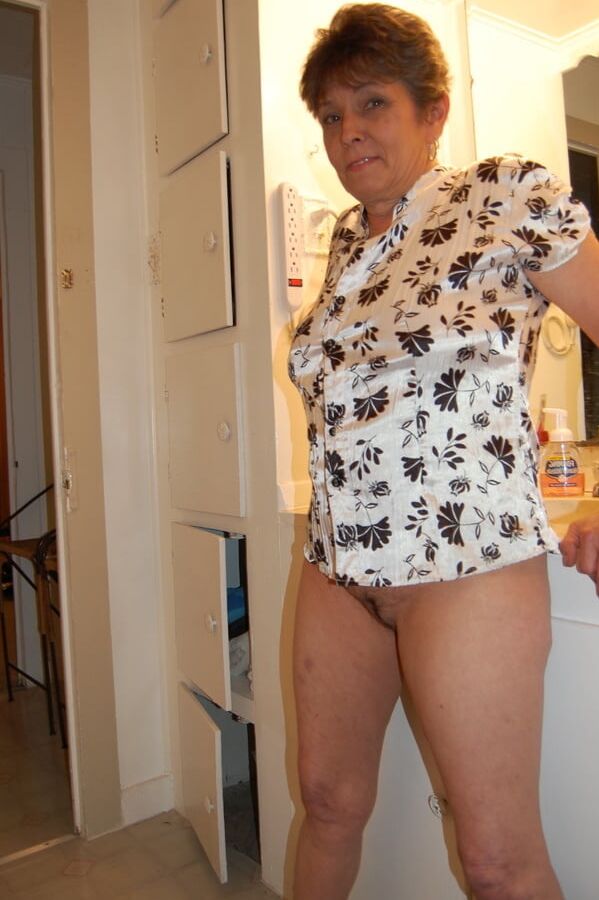 Granny spreads and shows hairy pussy
