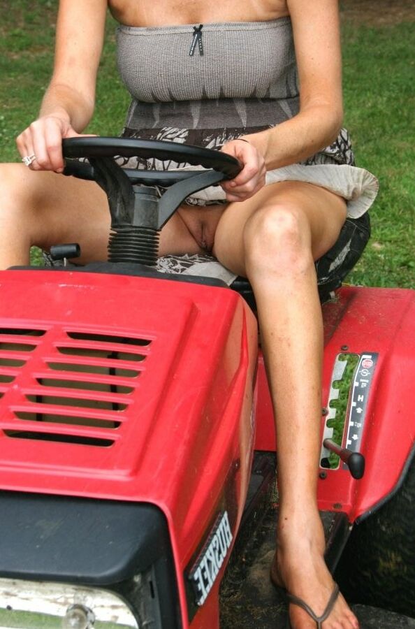 Neighbor lady mowing her lawn today
