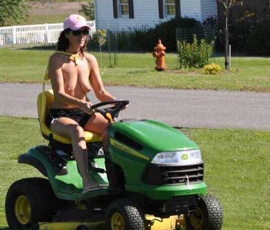Neighbor lady mowing her lawn today
