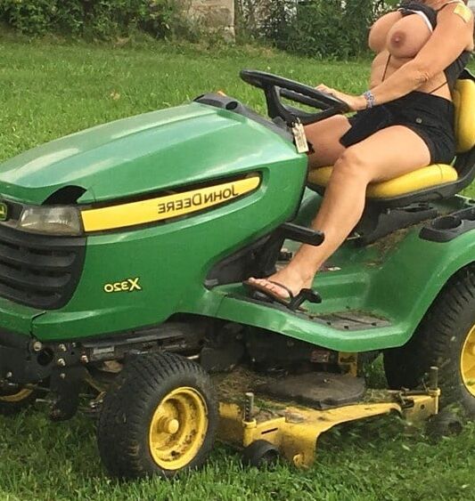 Neighbor lady mowing her lawn today