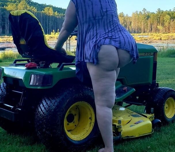 Neighbor lady mowing her lawn today