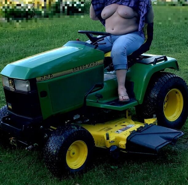 Neighbor lady mowing her lawn today