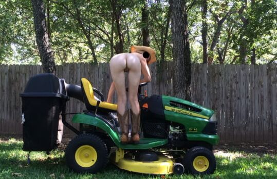 Neighbor lady mowing her lawn today
