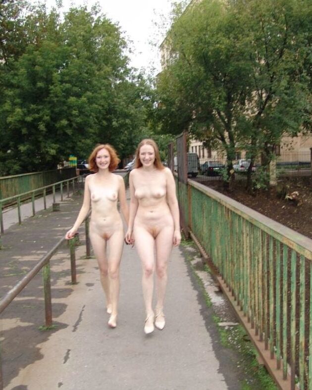 Two completely naked red-haired girls on city streets