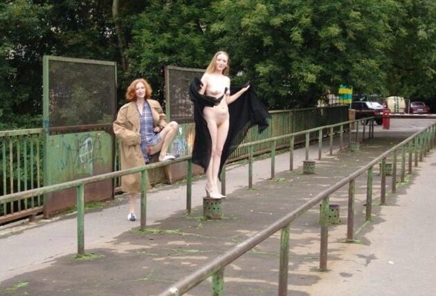 Two completely naked red-haired girls on city streets