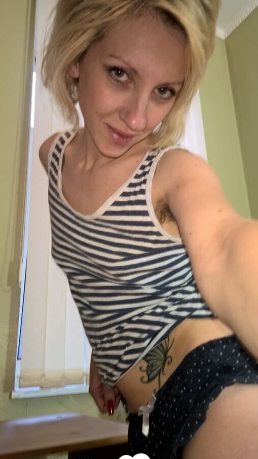 Cute blonde shows her tattoo and bush