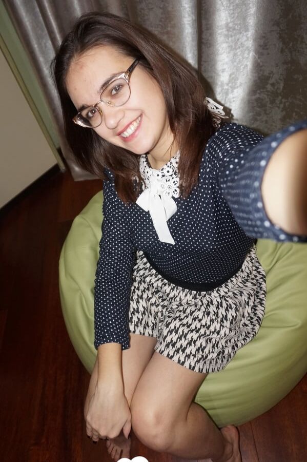 Nerdy cutie displays the tattoo on her chest