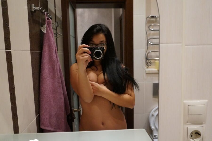 Cute nerdy babe taking some hot selfies