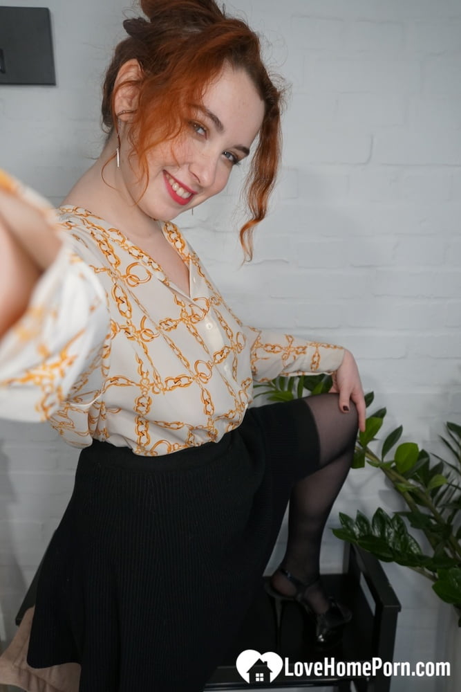 Stunning redhead in stockings shows off her ass