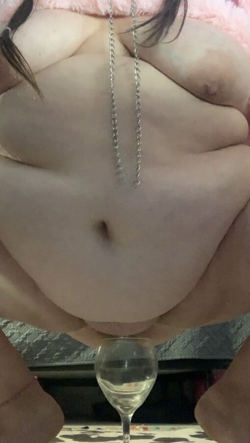 Fat piggy squats over wine glass