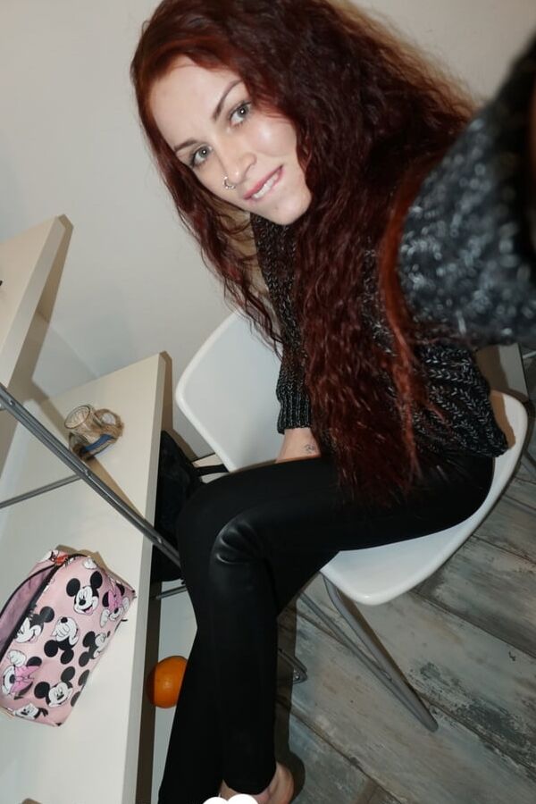 Beautiful redhead babe posing around her apartment
