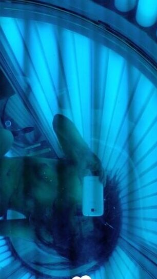 Asian sweetie taking selfies while tanning her body