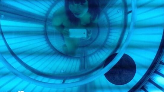 Asian sweetie taking selfies while tanning her body