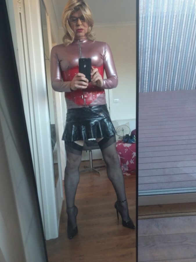 Back as a short blonde latex girl