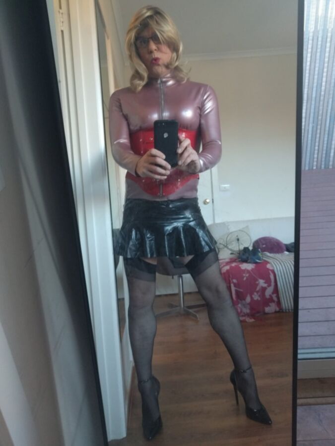 Back as a short blonde latex girl