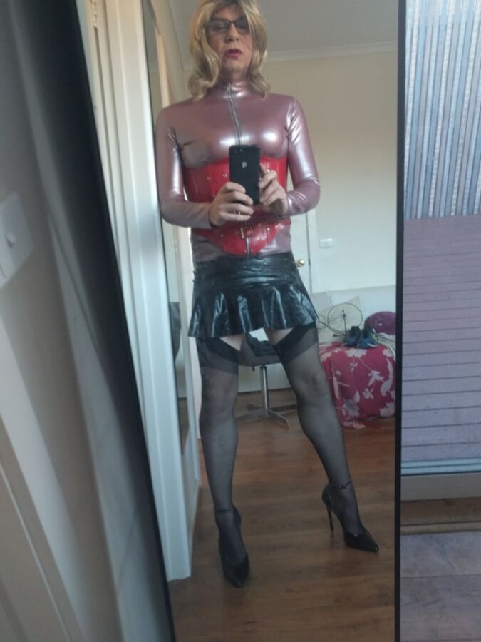 Back as a short blonde latex girl
