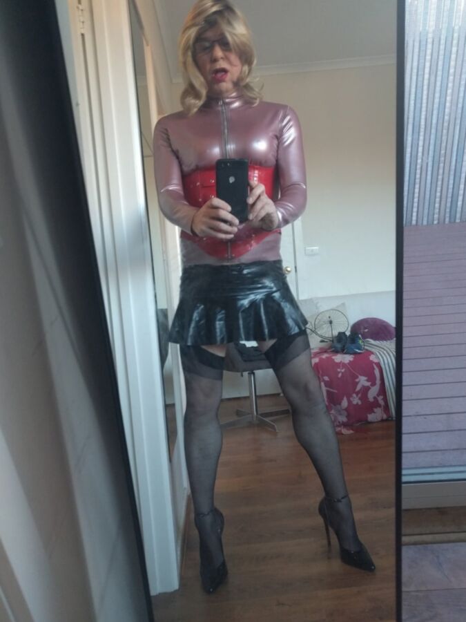 Back as a short blonde latex girl