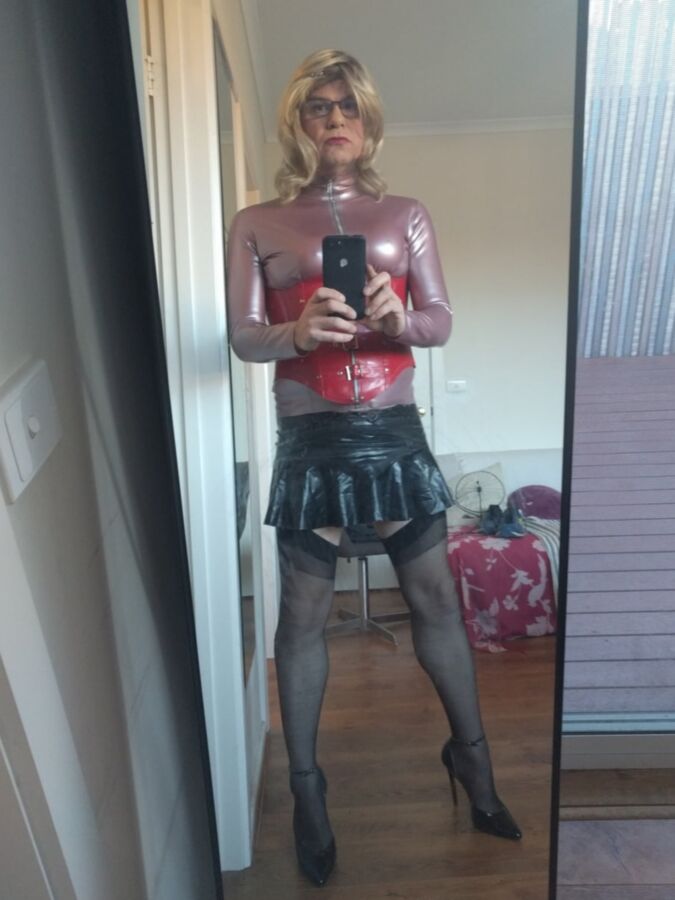 Back as a short blonde latex girl