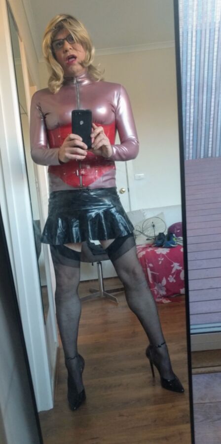 Back as a short blonde latex girl