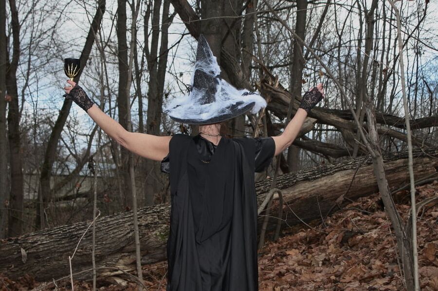 Witch with broom in forest