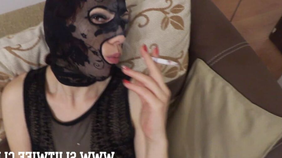 Masked slut smokes a cigarette and gets jerked on her face