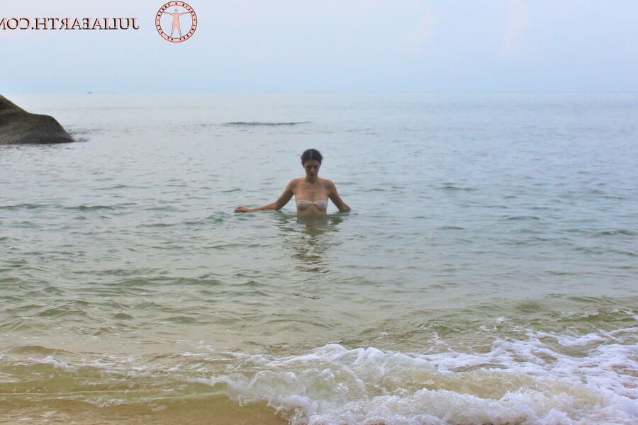 Part . Julia V Earth in white bikini at the beach.