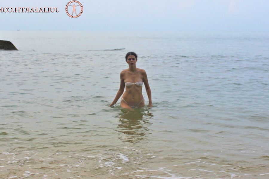 Part . Julia V Earth in white bikini at the beach.
