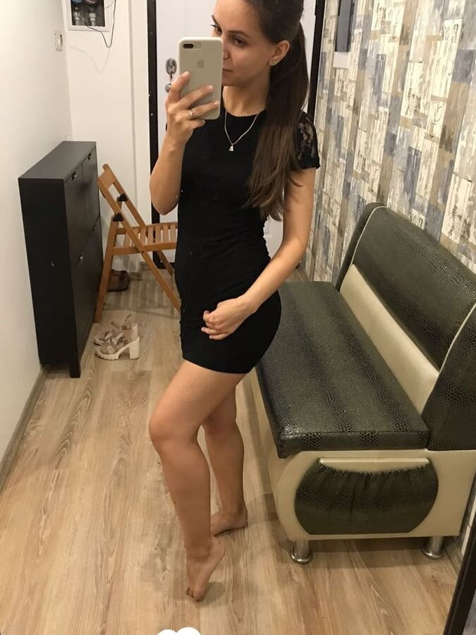 Kinky brunette taking pics while stripping her clothes