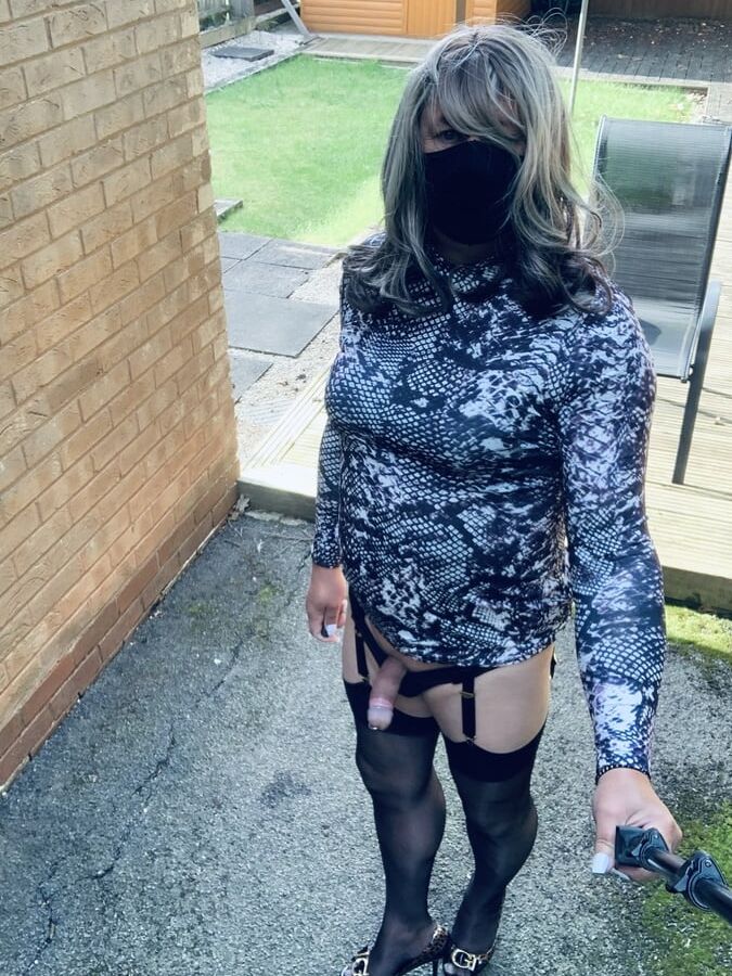 Kelly in snake skin pattern dress and black stockings