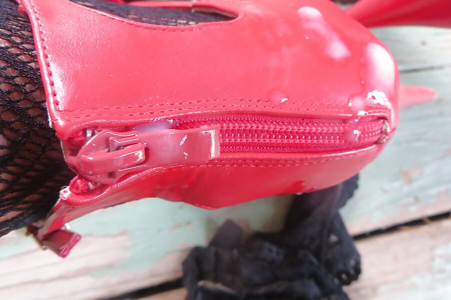cummed red zipper of her ankle strap heels