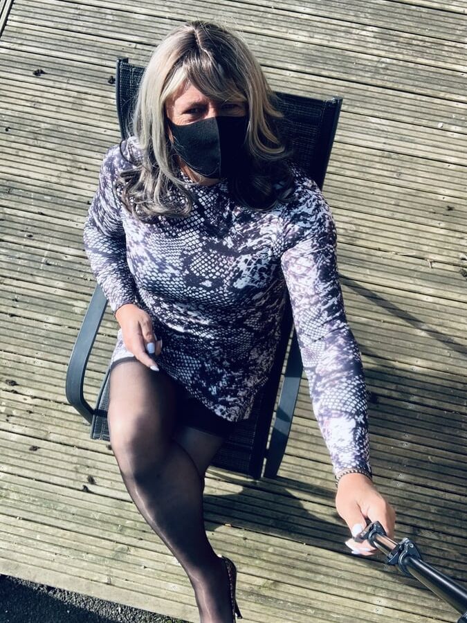 Kelly in snake skin pattern dress and black stockings