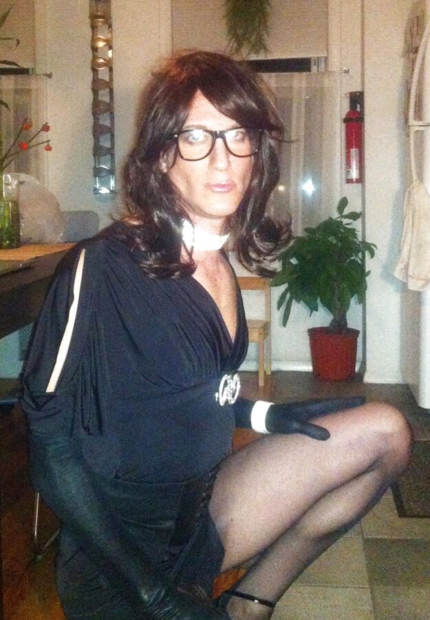 Crossdresser in black party dress, seamed pantyhose