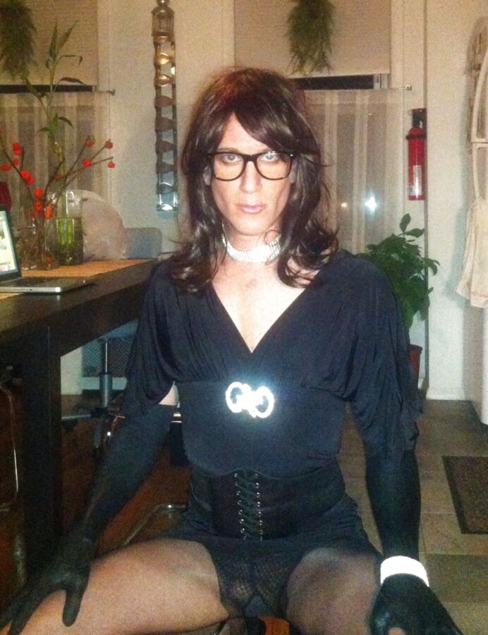 Crossdresser in black party dress, seamed pantyhose
