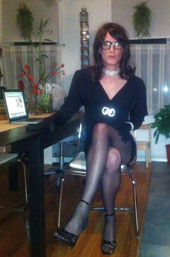 Crossdresser in black party dress, seamed pantyhose