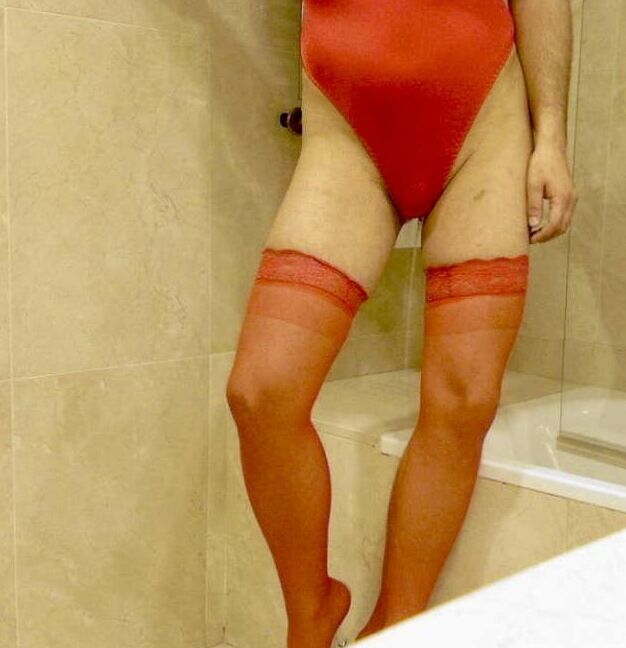 Wetting myself in my red body and stockings oops!