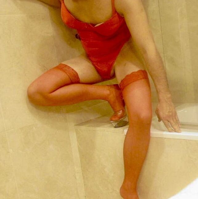 Wetting myself in my red body and stockings oops!