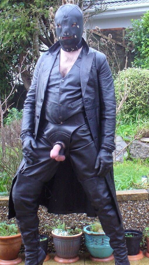 Leather Master in cock harness, boots and hood