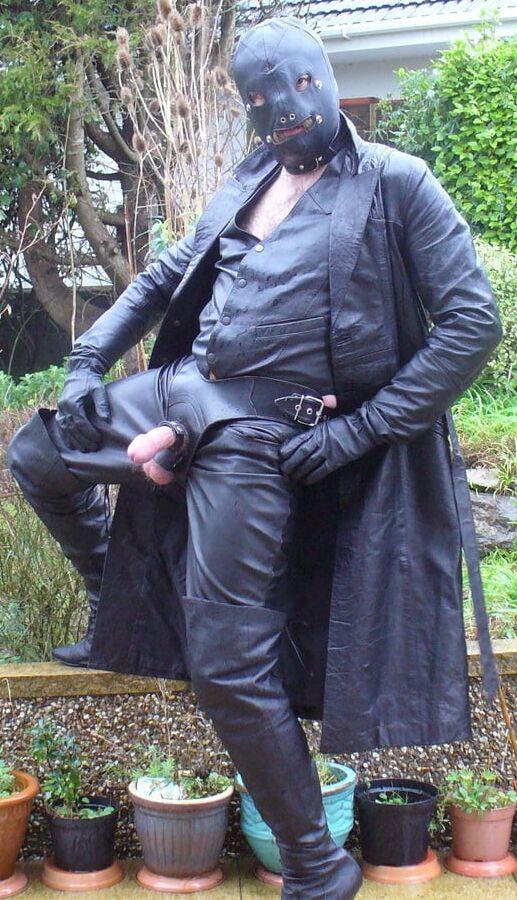 Leather Master in cock harness, boots and hood