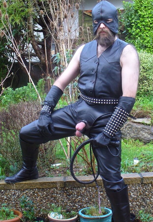 Leather Master in cock harness, boots and hood