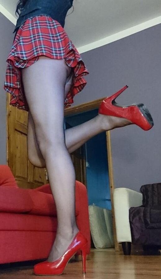 Crossdresser Marie in tartan mini skirt and sheer pantyhose