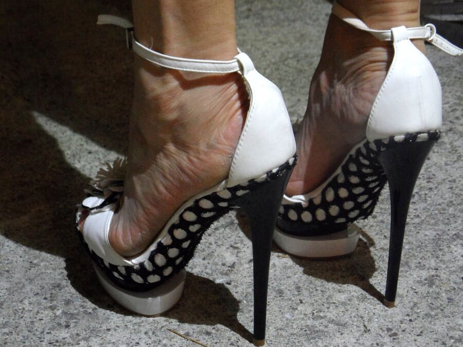 abusing her black and white platform heels