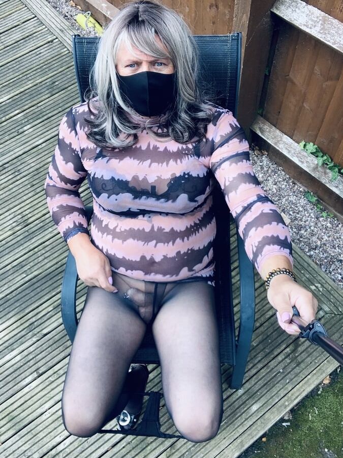 Kelly in see thru pink and black dress black tights