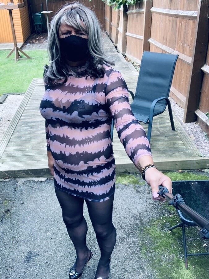 Kelly in see thru pink and black dress black tights