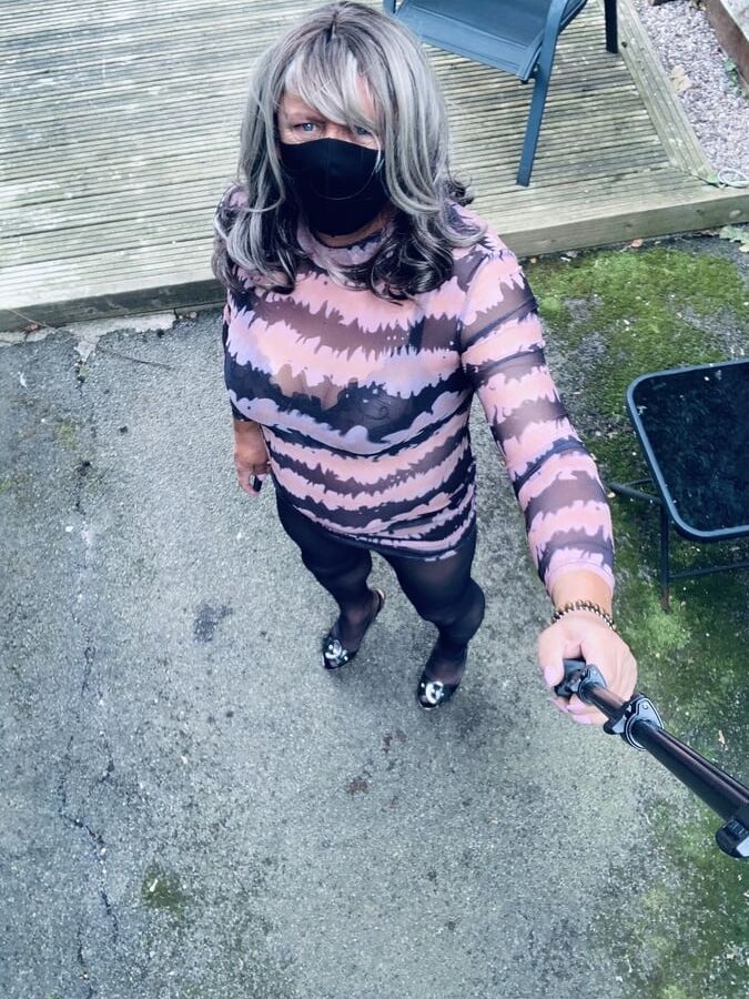 Kelly in see thru pink and black dress black tights